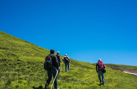 hikers with backpacks and trekking poles walking in Turkish highland