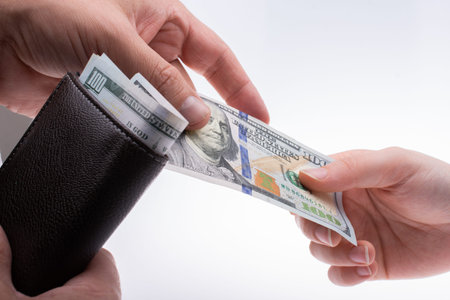 Businessman giving and receiving  US dollar banknote money