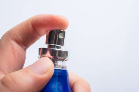 push button by spraying blue sanitizer bottle. Protection against virus, health care concept.の写真素材