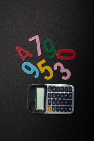 Mathematics learning concept. Colored numbers beside calculator.