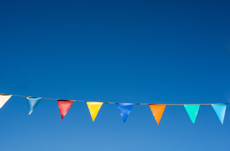 Colorful triangle bunting flags of various colors as festival concepの写真素材