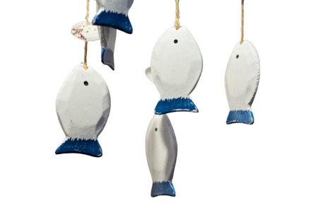 Decorative white and blue wooden fish in a gift shop. Handmade wooden carved fish.