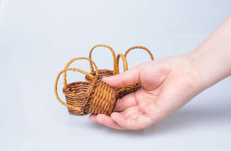 Hand holding Little size Empty wicker basketsの写真素材