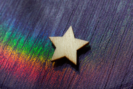 Wooden star shape on colorful fabric backgroundの写真素材