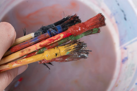 Paint brushes on technique ebru art on wooden background