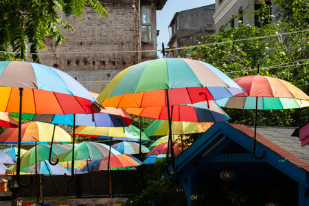 Rows Umbrellas floating above the street protecting from Sunlightの写真素材