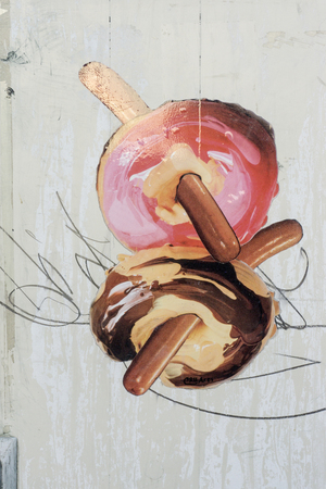 Wall art of donuts and sausages on wall in Berlin, Germanyのeditorial素材