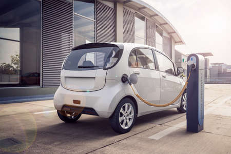 3d rendering of Electric car or vehicle at charging station charges battery with cable or charger for ecological range and sustainable energyの写真素材