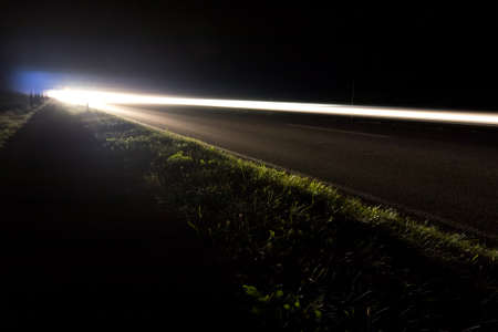 car lights on a road by nightの写真素材