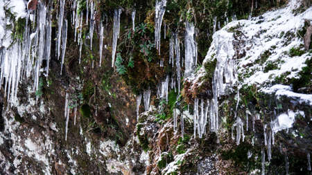 icicles and snow on a rock in winterの写真素材
