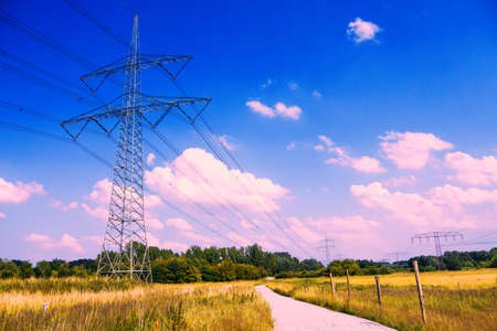 electrical tower in lanscape with blue violet sky in summerの写真素材
