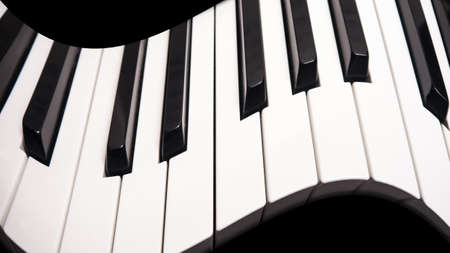 curved piano keys, abstract photo with black backgroundの写真素材