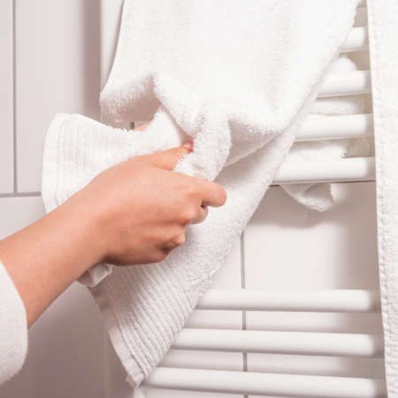 dry hands on a towel, heating in backgroundの写真素材