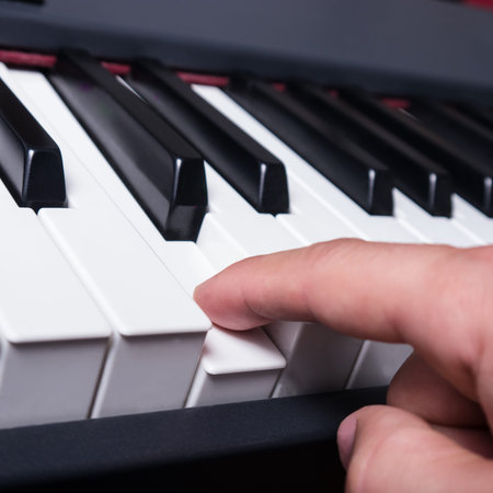 piano key and hand on c