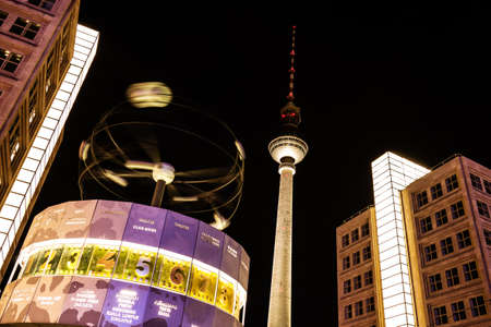 World clock and television tower in berlin by nightの写真素材