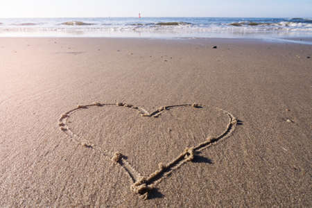 heart in sand at the beachの写真素材