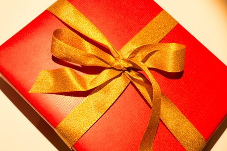 red christmas present with golden loop