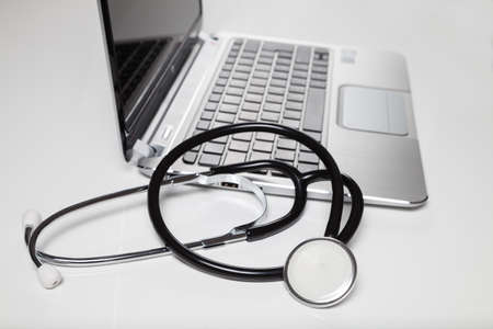 stethoscope and laptop on deskの写真素材