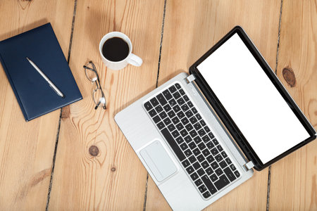 laptop, cup of coffe and notebook on wooden floor