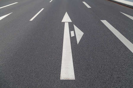 arrow in two directions on asphaltの写真素材