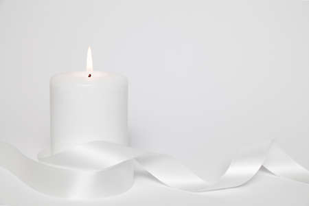 white candle and loop on white backgroundの写真素材