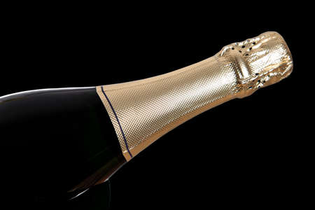 champagne bottle isolated on black backgroundの写真素材