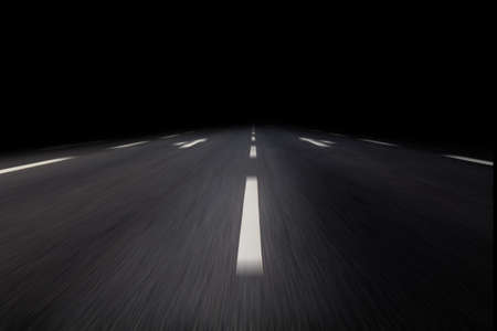 driving on asphalt by nightの写真素材