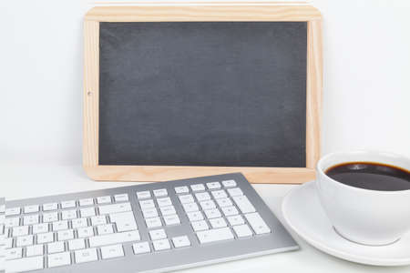 coffee and keyboard with blackboardの写真素材