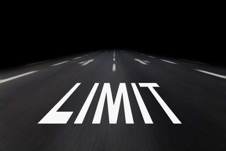 limit written on asphalt by nightの写真素材