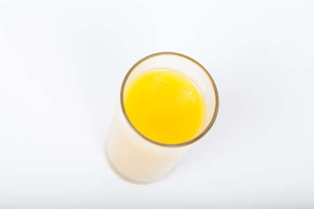 glass orange top view on whiteの写真素材