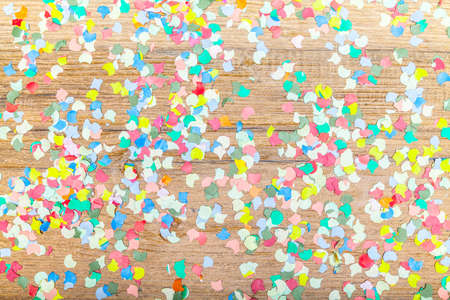 confetti background on wooden plateの写真素材