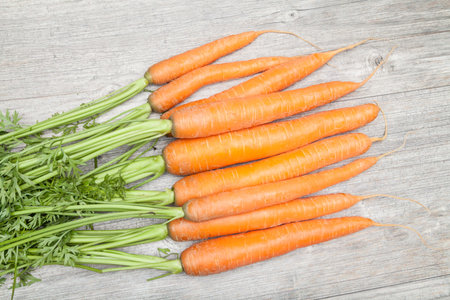 bunch carrots on wooden plate