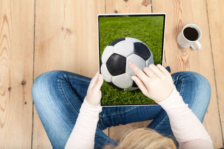 woman pointing on soccer ball on tabletの写真素材