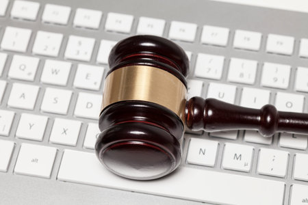 Wooden hammer on keyboardの写真素材