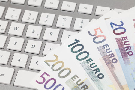 Banknotes Euro on keyboardの写真素材
