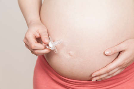 Pregnant holding pacifierの写真素材