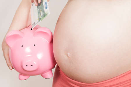 Pregnant and piggy bankの写真素材