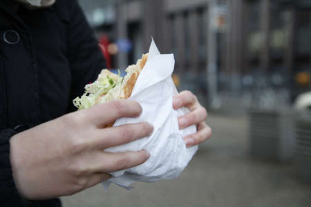 Woman eating a Doner Kebab in Berlinの写真素材
