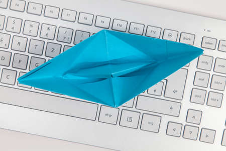Paper ship on keyboardの写真素材