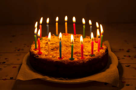 Burning candles on a birthday cakeの写真素材