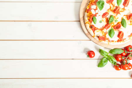 Pizza Margherita on wooden tableの写真素材