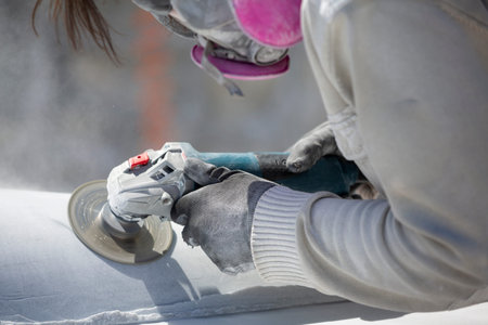 worker cutting stone with grinder