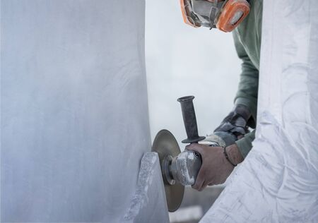 worker cutting stone with grinderの写真素材