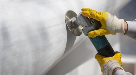 worker cutting stone with grinderの写真素材