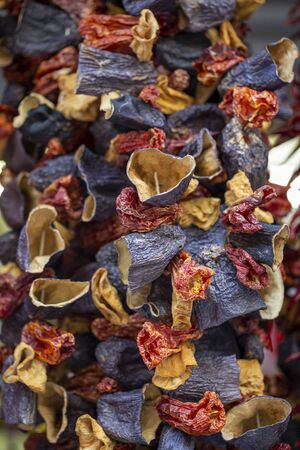 Dry eggplant and dry bell chili hanging on sale at shopの写真素材