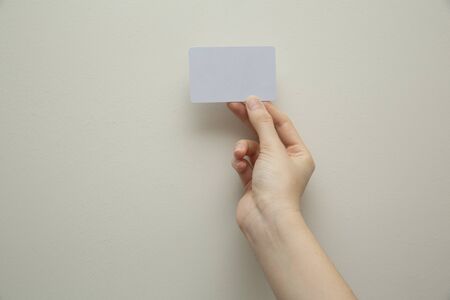 hand holding white cardの写真素材