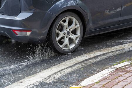 tire splashing in waterの写真素材
