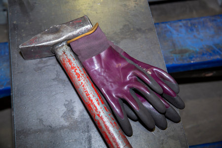 industrial hammer and gloves on a white background