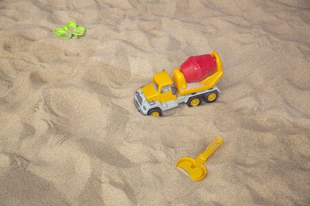 Bright plastic children's toys in the sand. Concept of beach recreation for children. Top viewの写真素材