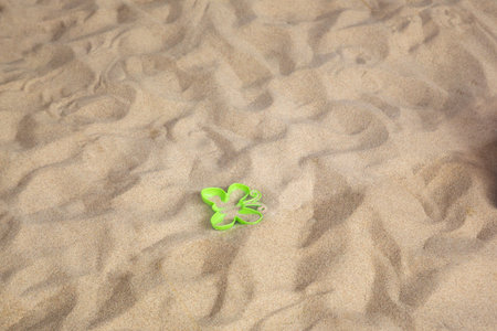Bright plastic children's toys in the sand. Concept of beach recreation for children. Top viewの写真素材